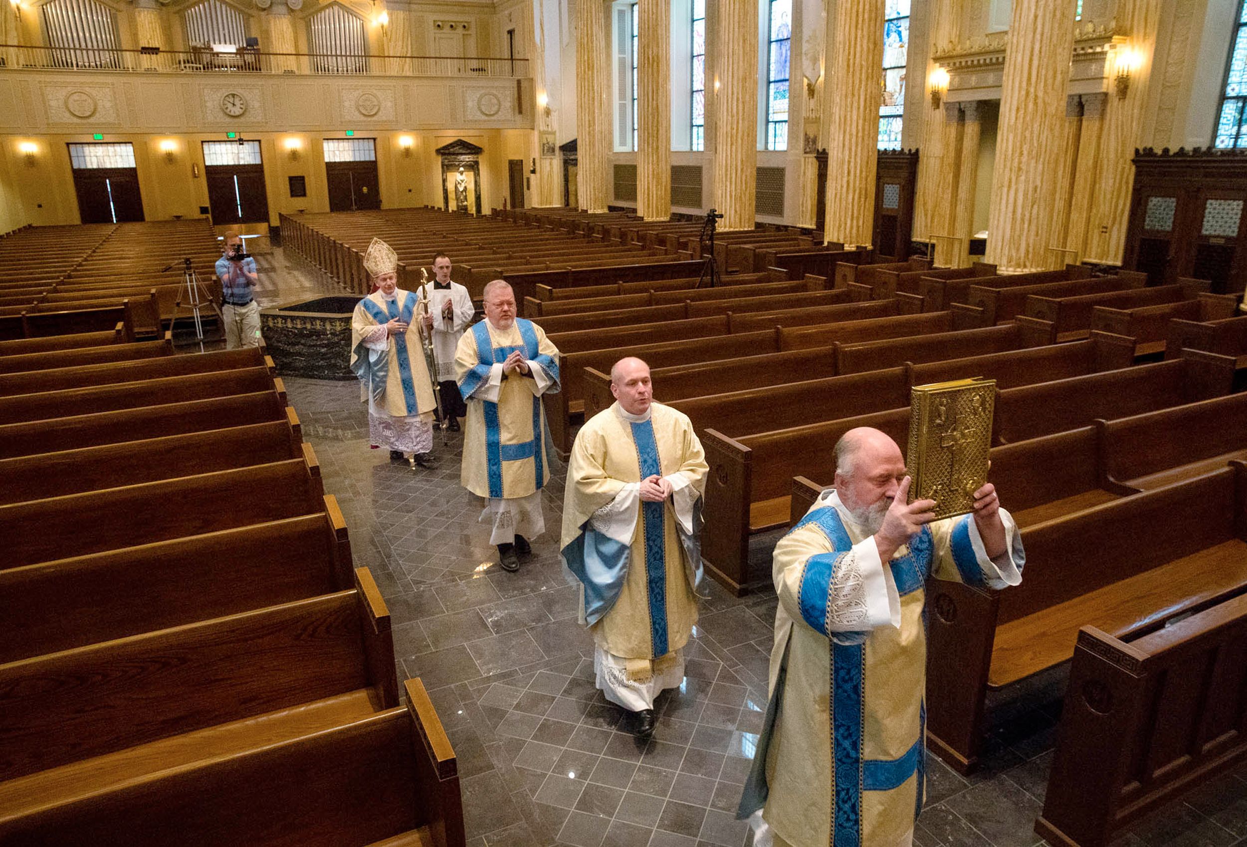 Deacon Larry Smith leads clergy procession into empty Springfield Cathedral during live-streamed Easter service, April 2020.