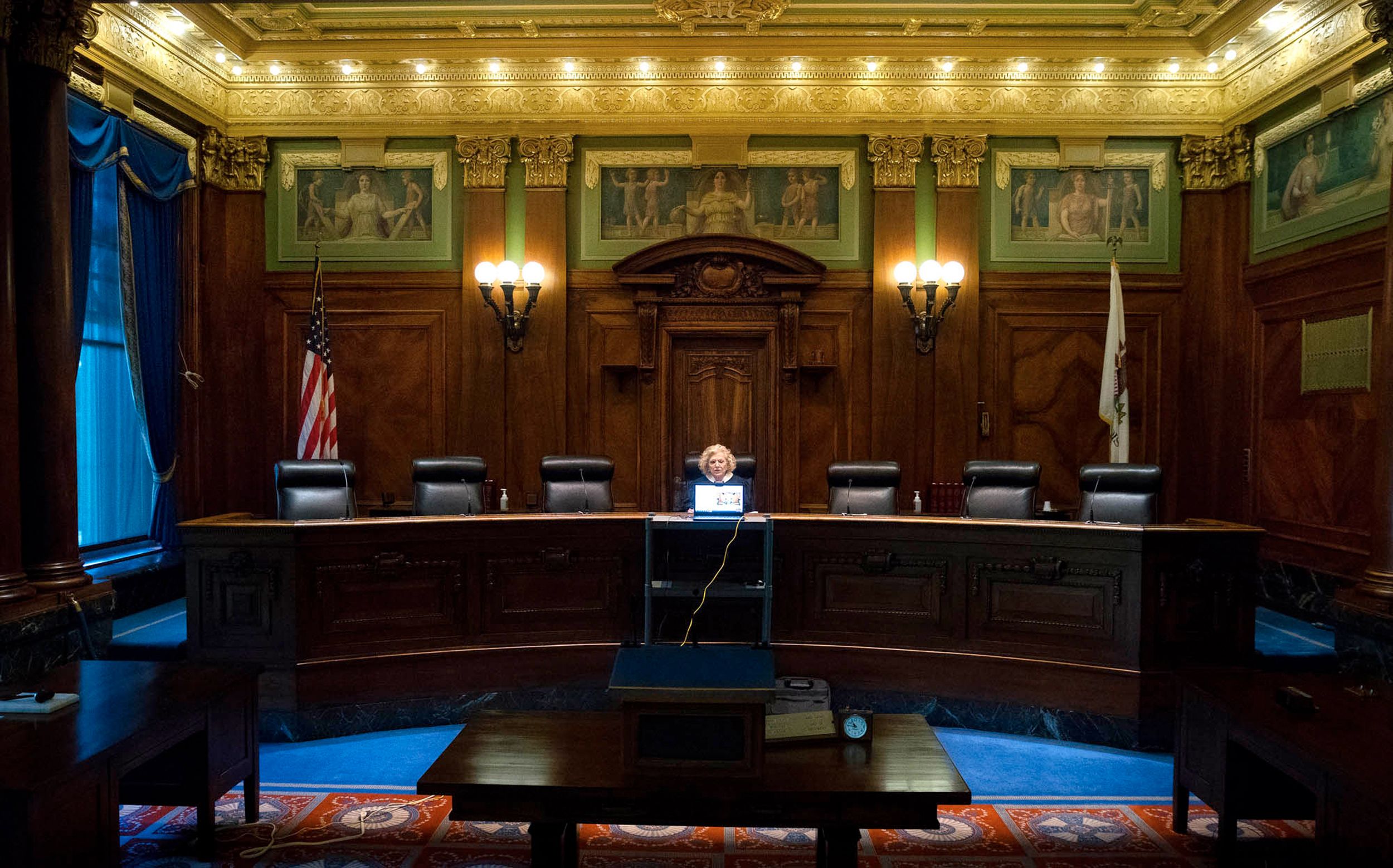 In an empty, wood-paneled courtroom Chief Justice Anne M. Burke administers attorney's oath via video to 300+ new lawyers at the Illinois Supreme Court, Springfield, May 2020.