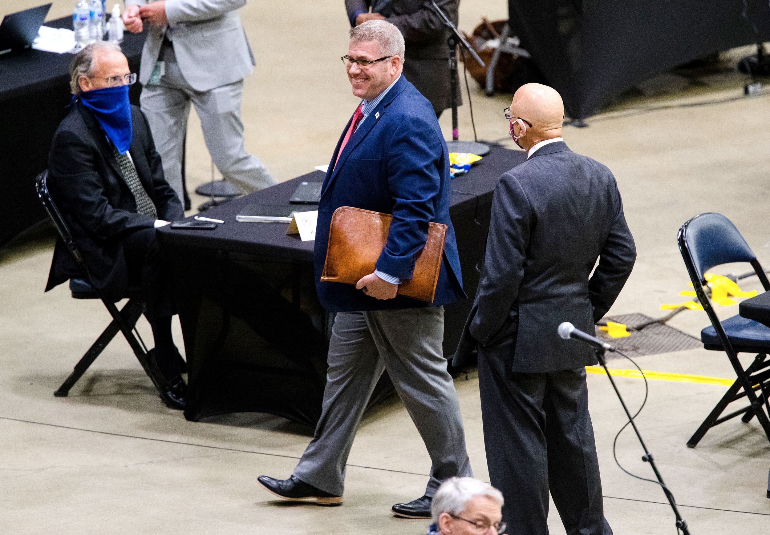 Illinois Rep. Darren Bailey wears a smile but not a mask as he leaves the Bank of Springfield Center after a vote to remove him for not wearing a mask, May 20, 2020.