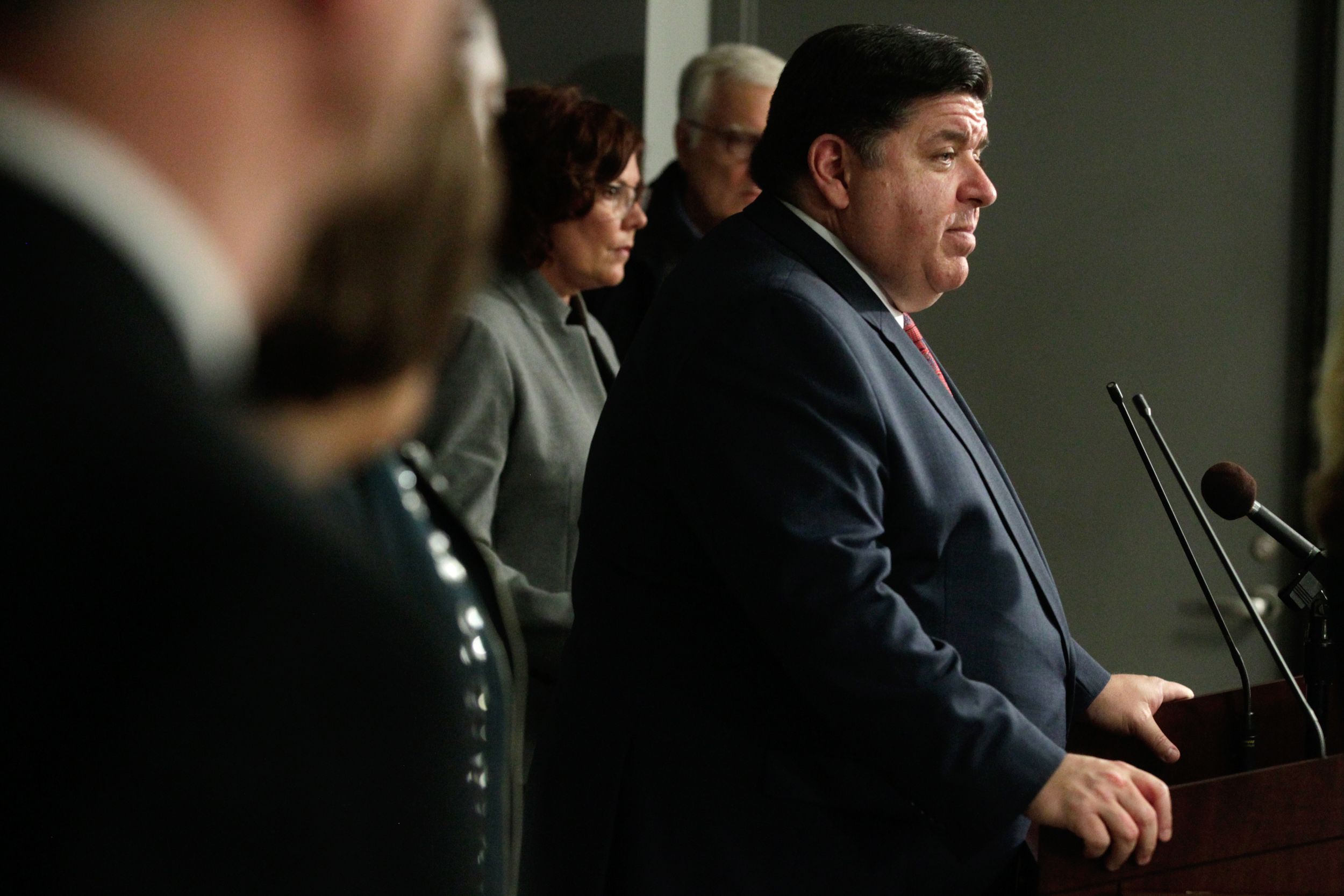 Illinois Gov. JB Pritzker speaks at podium during press briefing, Springfield, March 16, 2020.